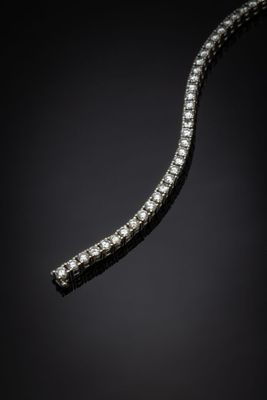 a diamond necklace on a black background