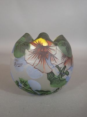 a vase with a flower on it sitting on a table