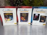 trois DVD sont posés sur une table devant un mur de pierre