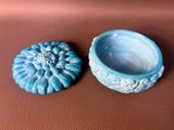 a small blue bowl and a small blue bowl on a brown surface