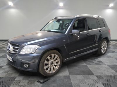 a picture of a blue mercedes suv parked in a garage