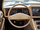 a steering wheel and dashboard of a car in a parking lot