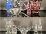 many different colored glass vases sitting on a table