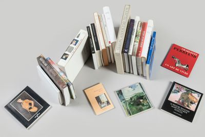 several books are stacked on top of each other on a table