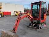 an image of a small excavator in a parking lot