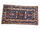 an antique persian rug with a blue and red design on a white background