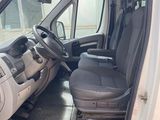 a white van with the door open and the driver ' s seat down