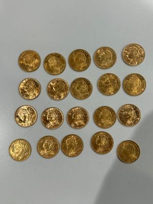 a lot of gold coins sitting on a white surface