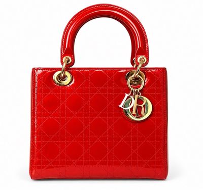 a close up of a red handbag on a white background