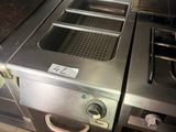 a picture of a commercial kitchen with stainless steel appliances