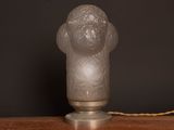 an image of a frosted glass lamp on a wooden table