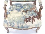 a blue and white chair with a floral upholstered back