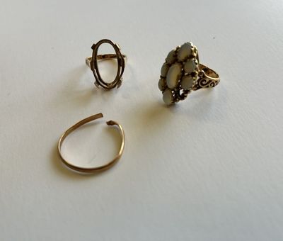 deux bagues et une bague posée sur une table, sur fond blanc