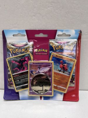 three packs of pokemon trading cards in a bag