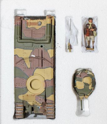 a toy tank with a soldier figure on it next to other items