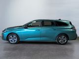 the blue car is parked in a large room with a white wall