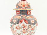 a vase that has a bird on top of it