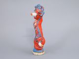 figurine of a red and blue seahorse holding a bottle of wine