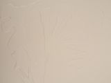 painting on the wall of a bathroom with a toilet and a sink