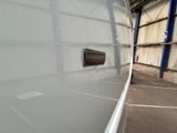an image of the inside of a building with the door open