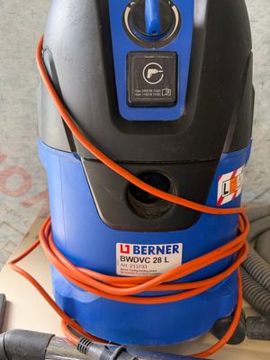 a blue and black vacuum sitting on top of a box