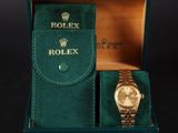 an image of a rolex watch in a box with a green velvet case