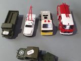 five toy vehicles that are lined up next to each other