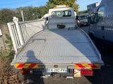 a white truck that is parked next to a white van