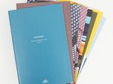 a stack of five notebooks sitting on top of each other