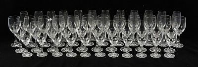 a lot of empty wine glasses on a black table