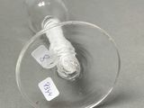a wine glass with a cigarette in it on a table