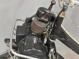 a black bike with an old fashioned engine on it