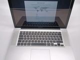 a laptop computer sitting on a table with a paper on the screen