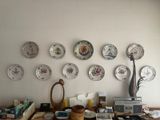 a lot of plates on the wall on the table