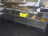 une étagère métallique sur laquelle sont posés de nombreux objets, dans une pièce