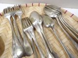 a lot of forks and spoons sitting on a plate