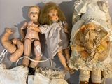 a lot of dolls that are sitting on a table