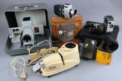 many different types of cameras and equipment sitting on a table