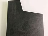 a piece of black paper sitting on top of a white table