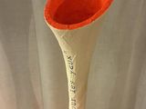 a vase with writing on it sitting on a table