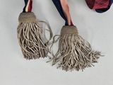 two tassels hanging from a hook on a wall