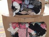 two boxes of clothes on a pallet in a store