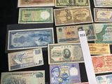 many different types of foreign currency on the table