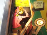 a close up of a pinball machine with a pinball on it