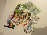 a pile of stamps on a table next to a laptop