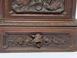 a wooden clock with carvings of animals on it