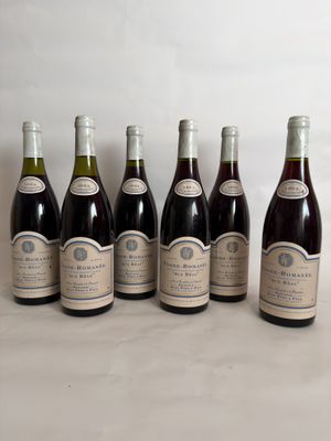 six bottles of wine lined up in a row on a table