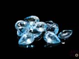 some very pretty blue diamonds on a black surface