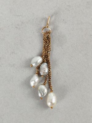 a close up of a pair of earrings with pearls hanging from them