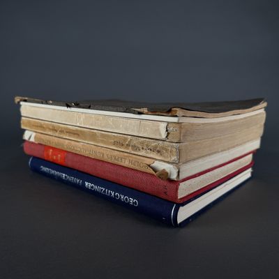 several books stacked on top of each other on a table